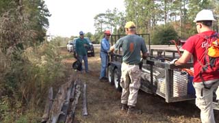 Larry, JP, Tom, and Nick unloading posts