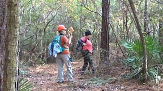 Mary clears debris for Wallis to access the tree