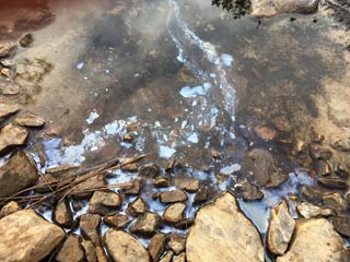 Creek water irridescence and reflections