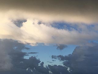 Cloud layers to the W. Fuzzier is closer