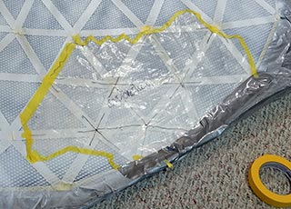 Cut strips of tape in half lengthwise for a flexible outline of continents, holding plastic masks