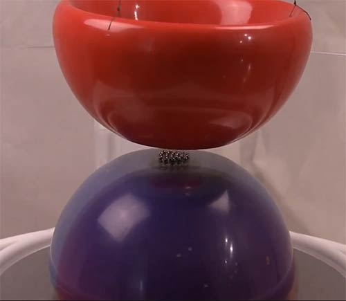 bowl-shaped magnetic field emitters as two cups of Wholeo symbol